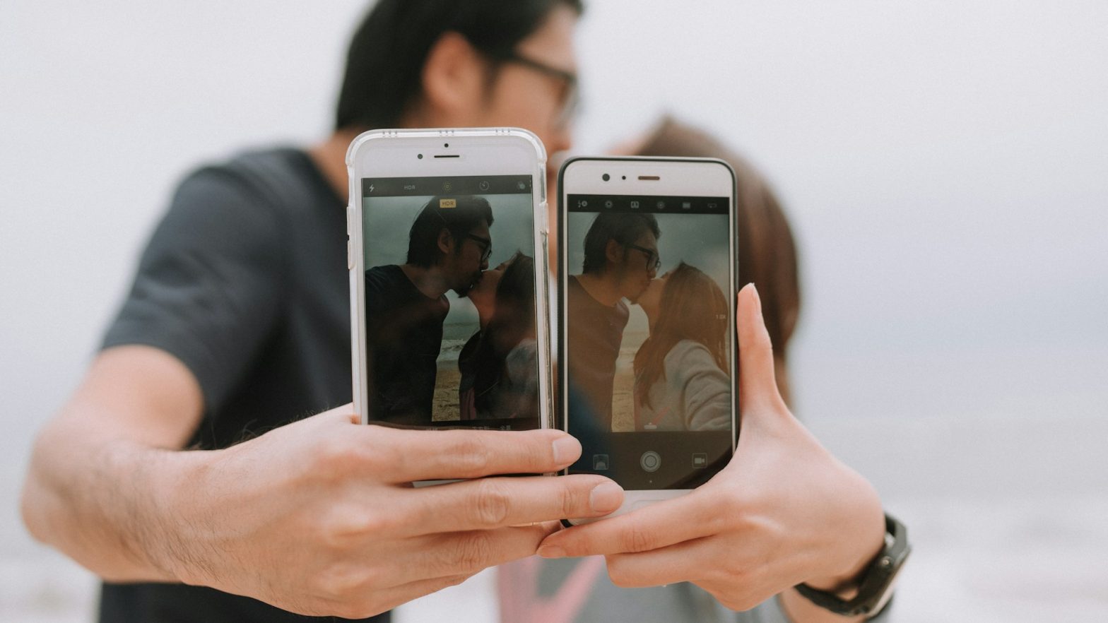 couple holding out two phones